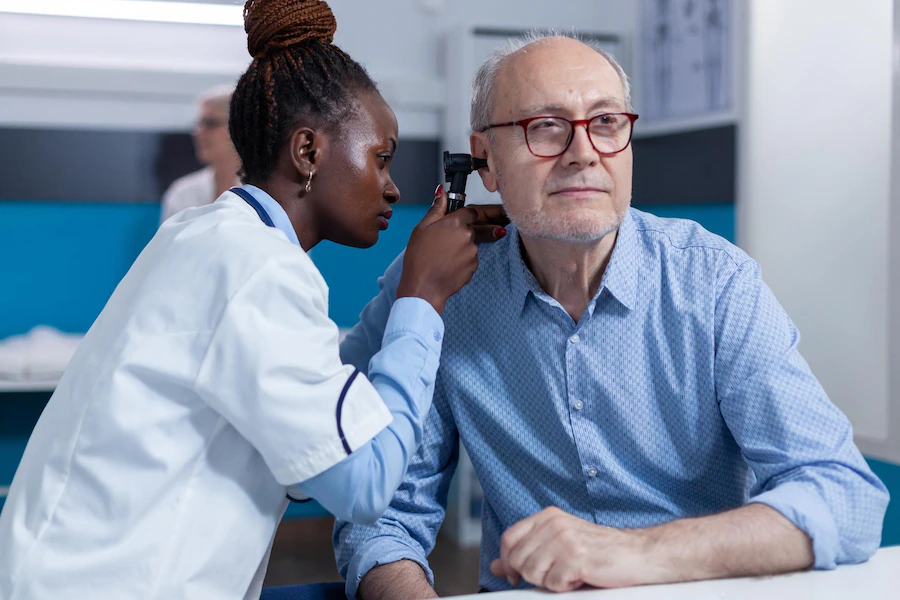 clinic otology specialist consulting senior patient using otoscope check ear infection hospital otologist examining sick retired man internal ear condition while doctor cabinet 482257 44402