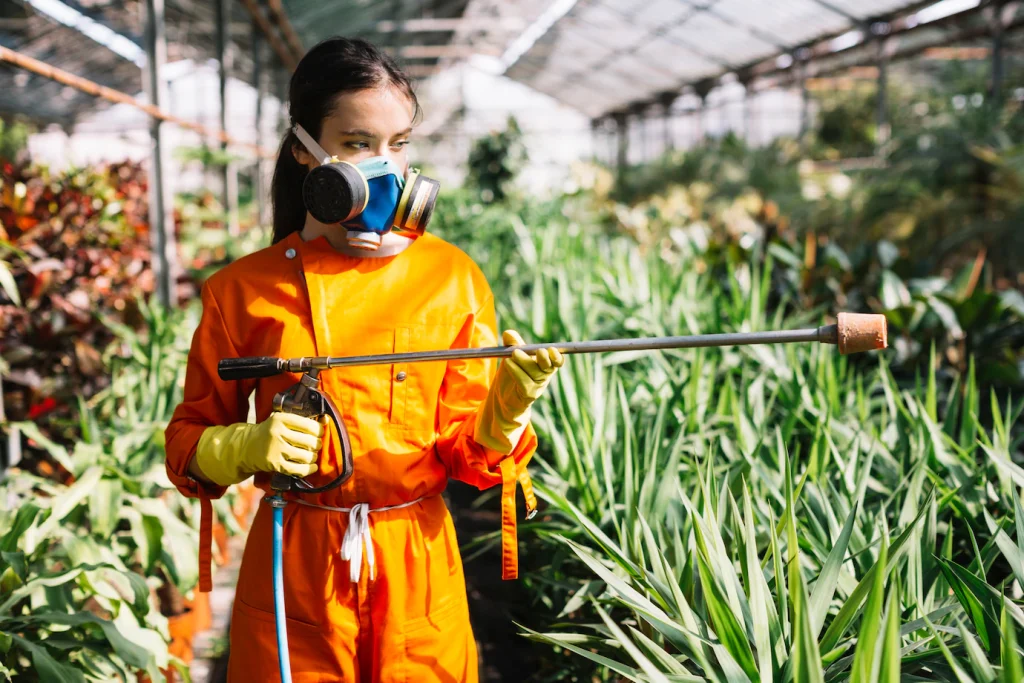 female gardener with sprayer standing greenhouse 23 2147918605